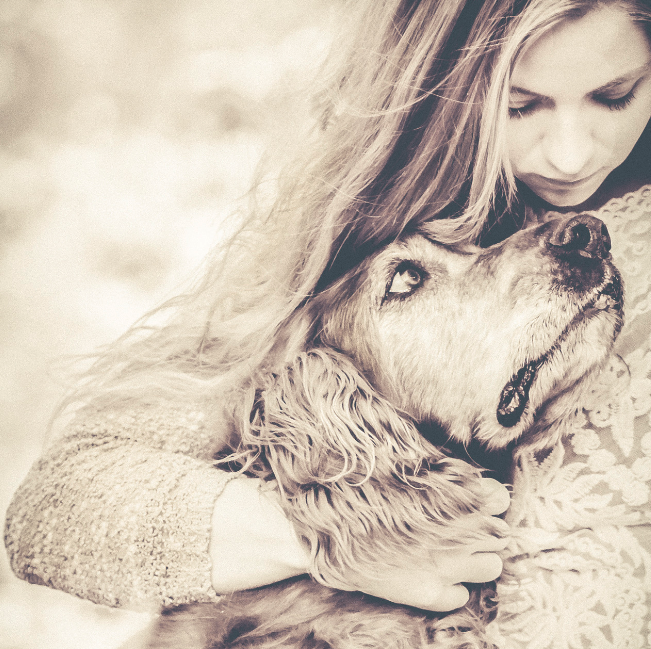 woman hugs elderly dog - animal communications